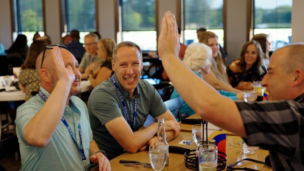 Hi-five at the social event for United Wholesale Team